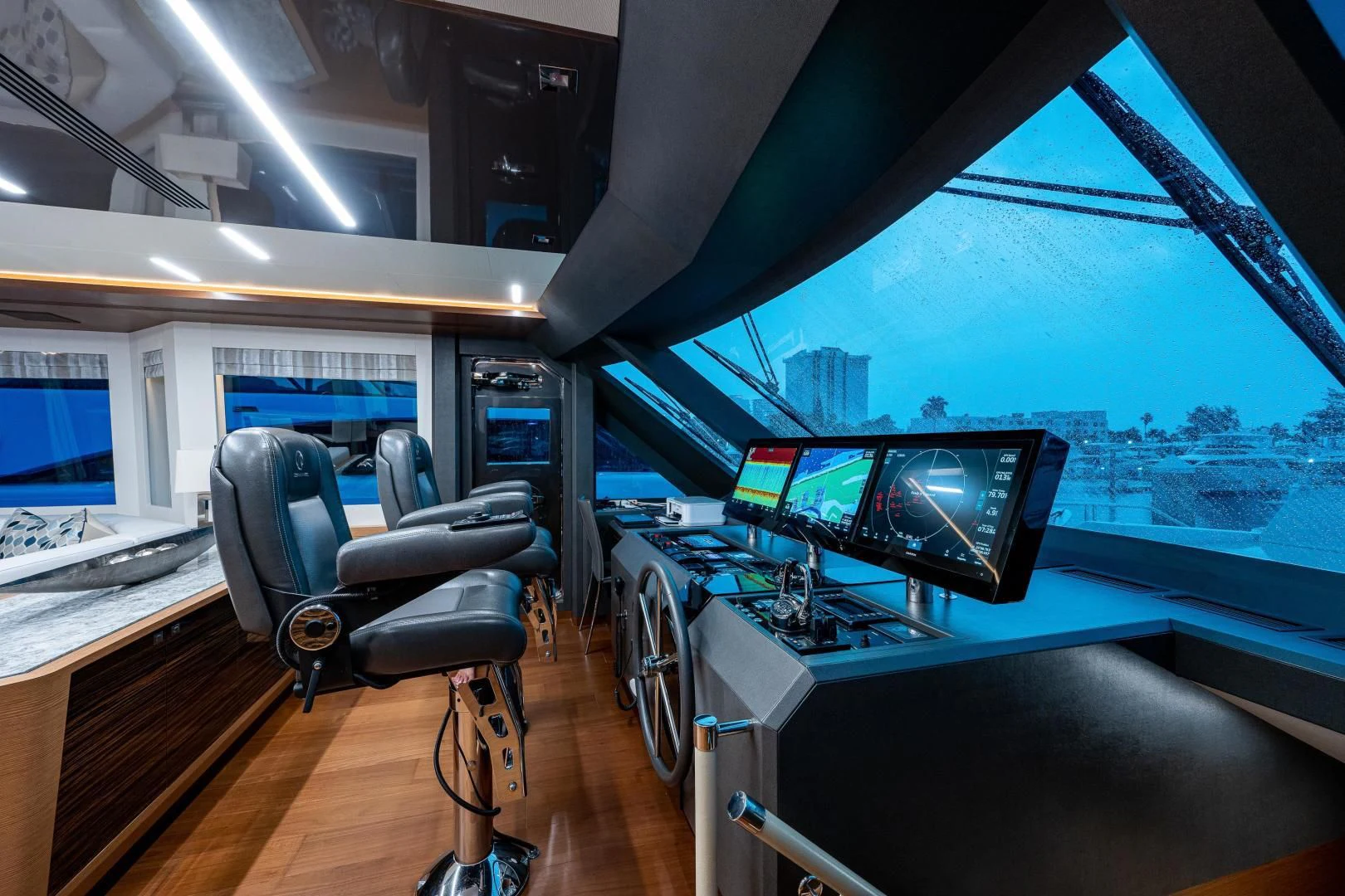 a room with a view of the city from the window aboard SEASUITE Yacht for Charter