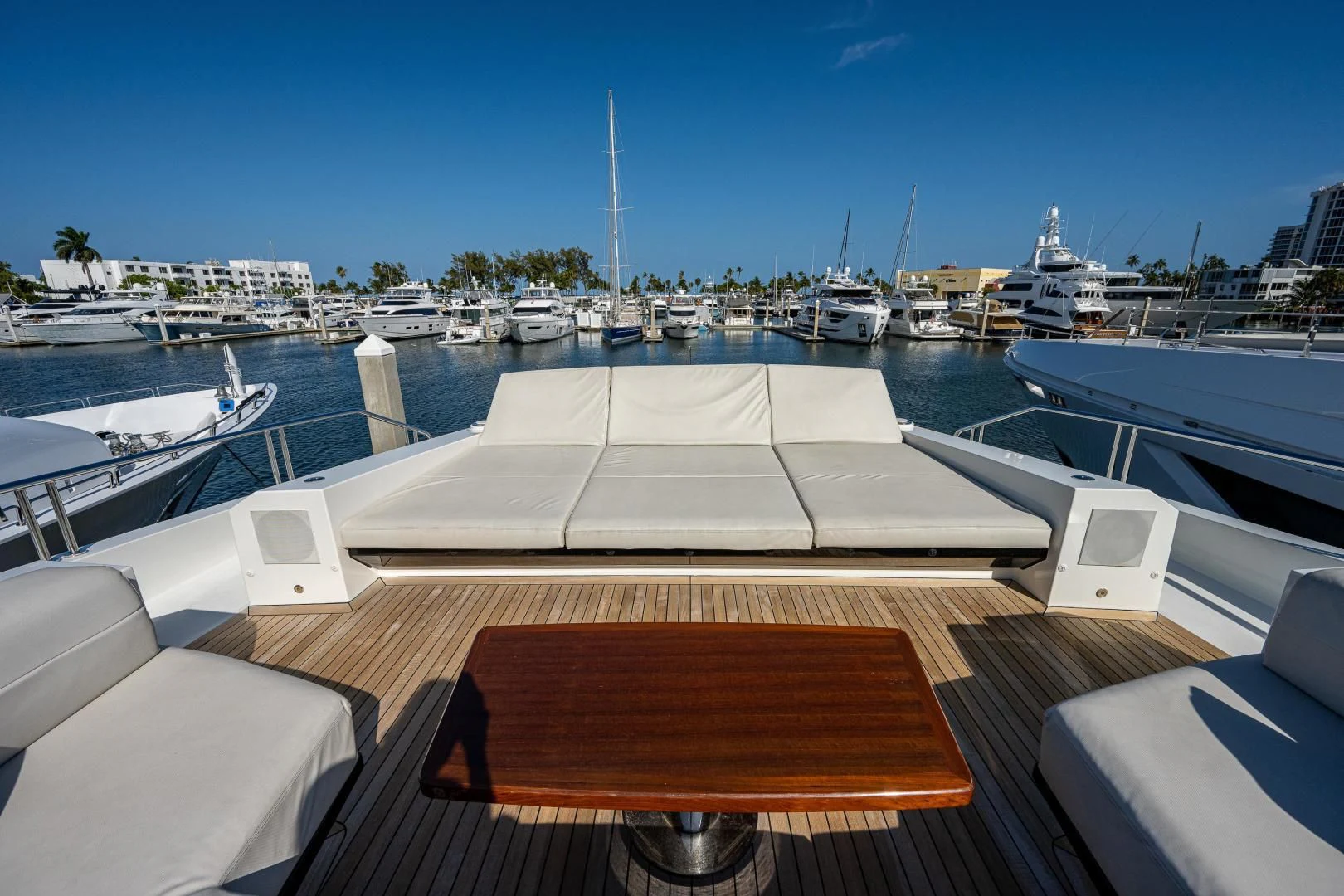 a deck with a boat and a dock with boats in the water aboard SEASUITE Yacht for Charter