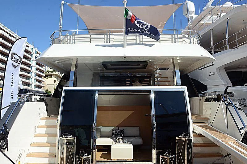 a large white boat with a flag on the front aboard SEASUITE Yacht for Charter