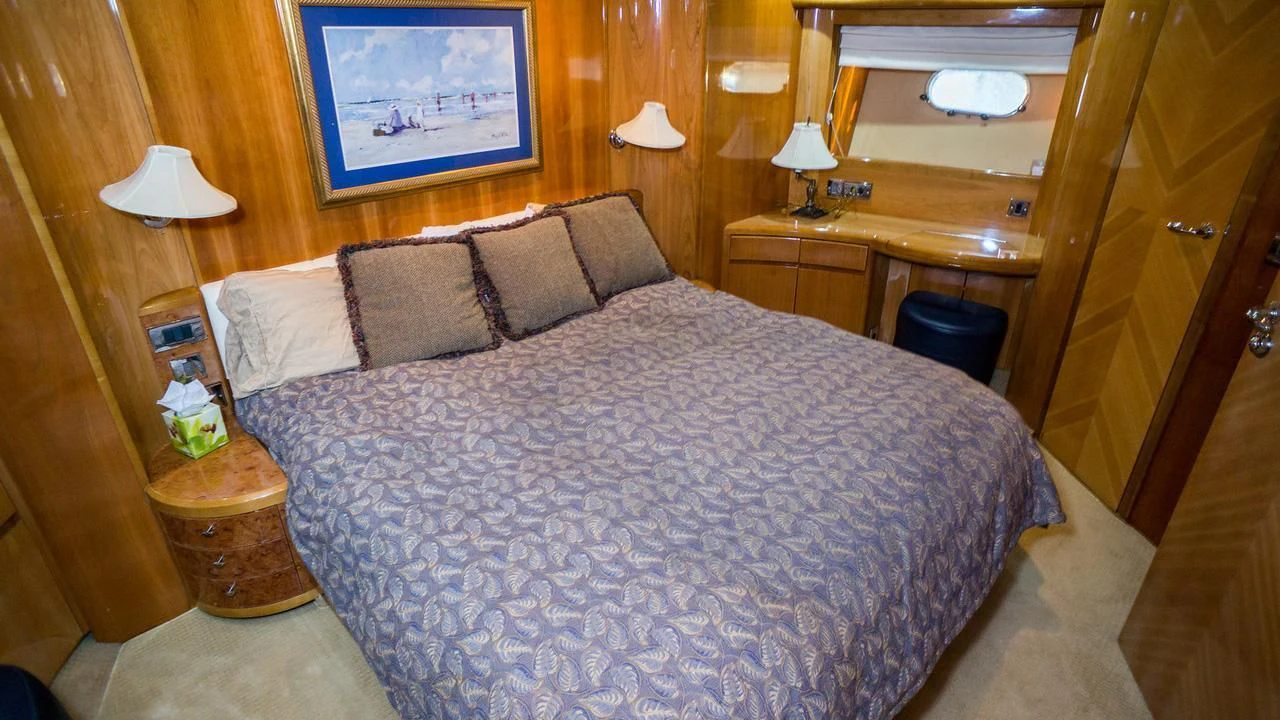 a bed with a white comforter aboard AVICCI Yacht for Sale