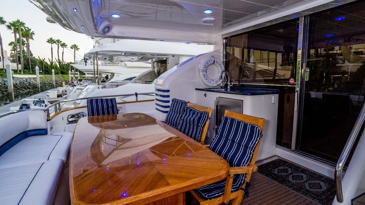 a table with chairs around it aboard AVICCI Yacht for Sale