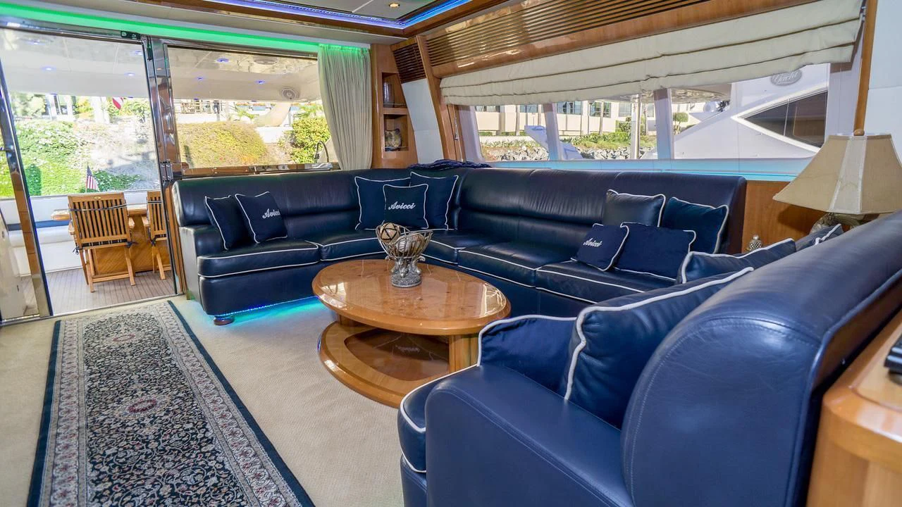 a living room with a blue couch aboard AVICCI Yacht for Sale