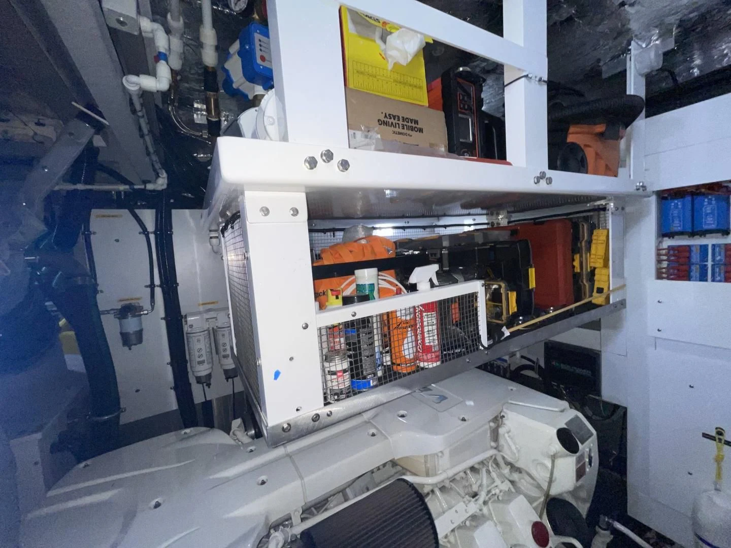 a white shelf with a few boxes on it aboard CAESURA Yacht for Sale