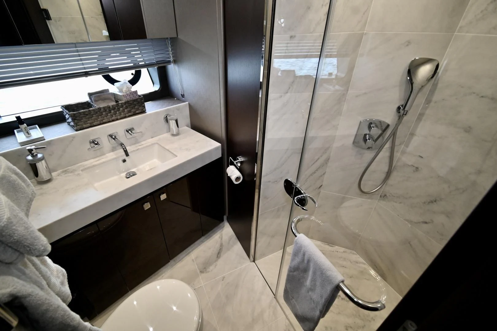 a bathroom with a shower sink and a mirror aboard CAESURA Yacht for Sale