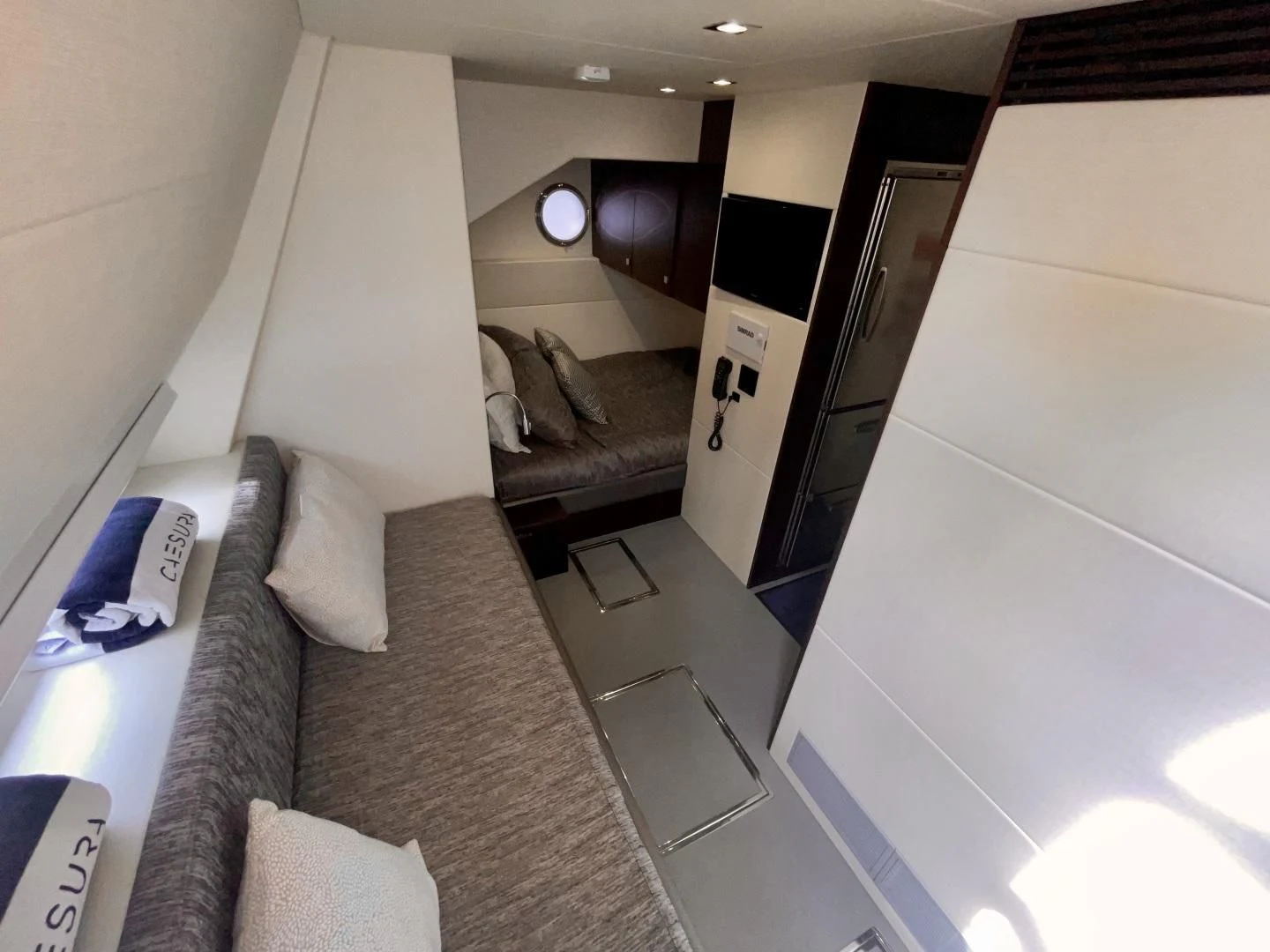 a room with a bed and a couch aboard CAESURA Yacht for Sale
