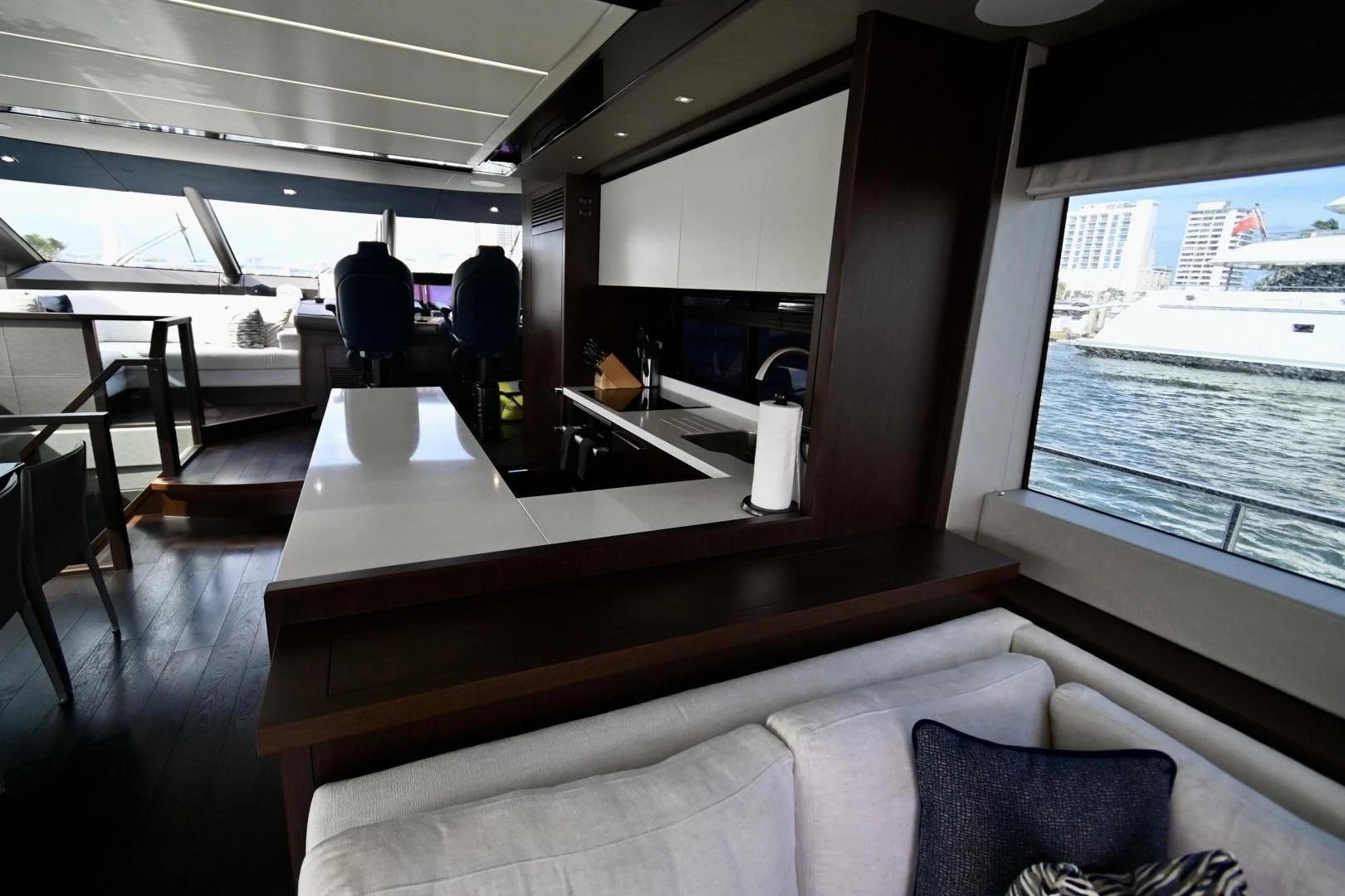 a room with a large window and a table with chairs aboard CAESURA Yacht for Sale