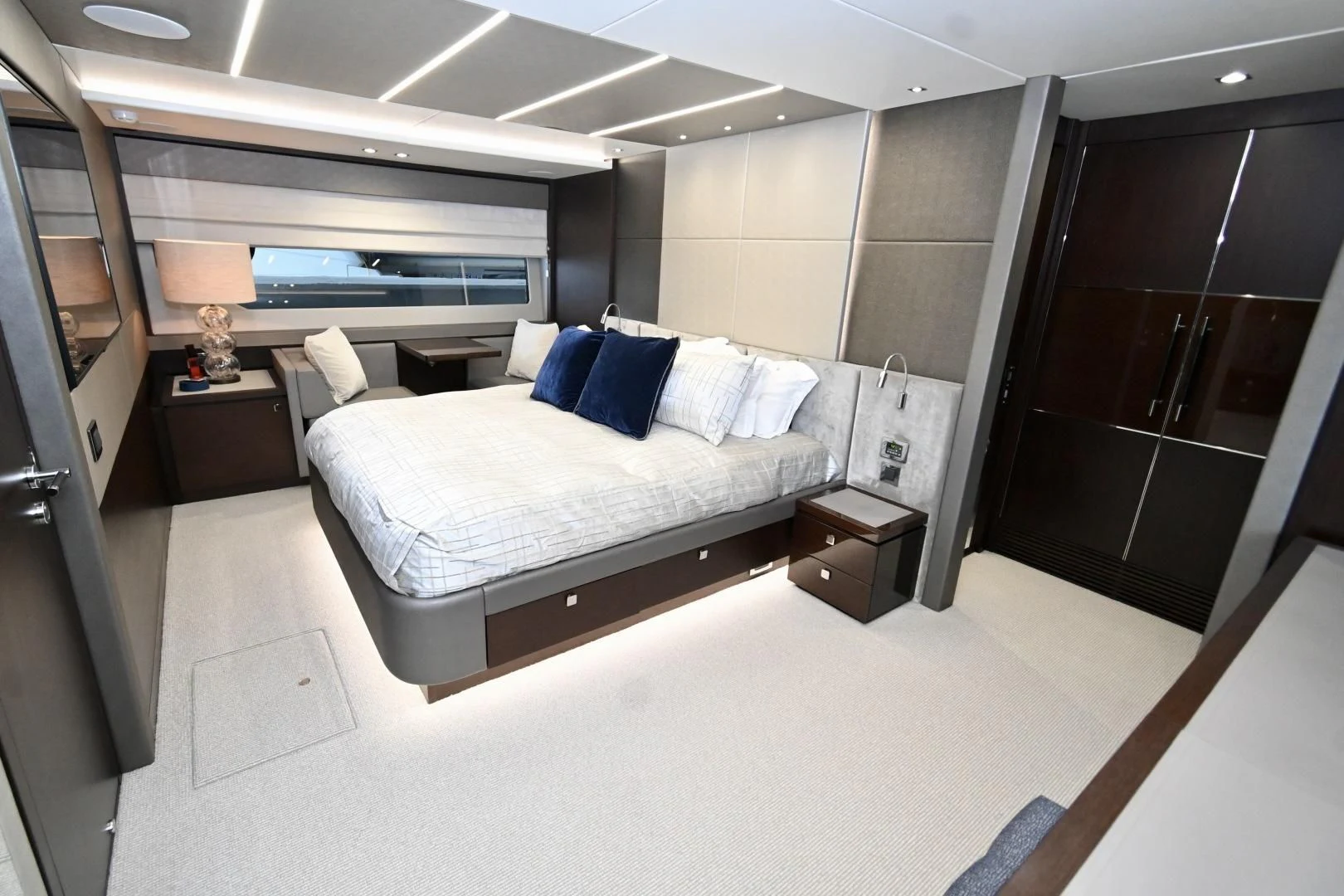 a room with a bed and a lamp aboard CAESURA Yacht for Sale