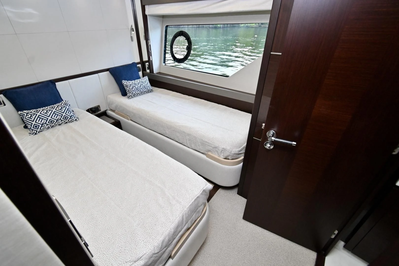 a bed next to a window aboard CAESURA Yacht for Sale