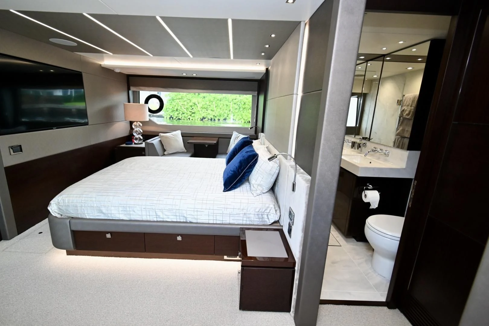 a bedroom with a bed and a mirror aboard CAESURA Yacht for Sale