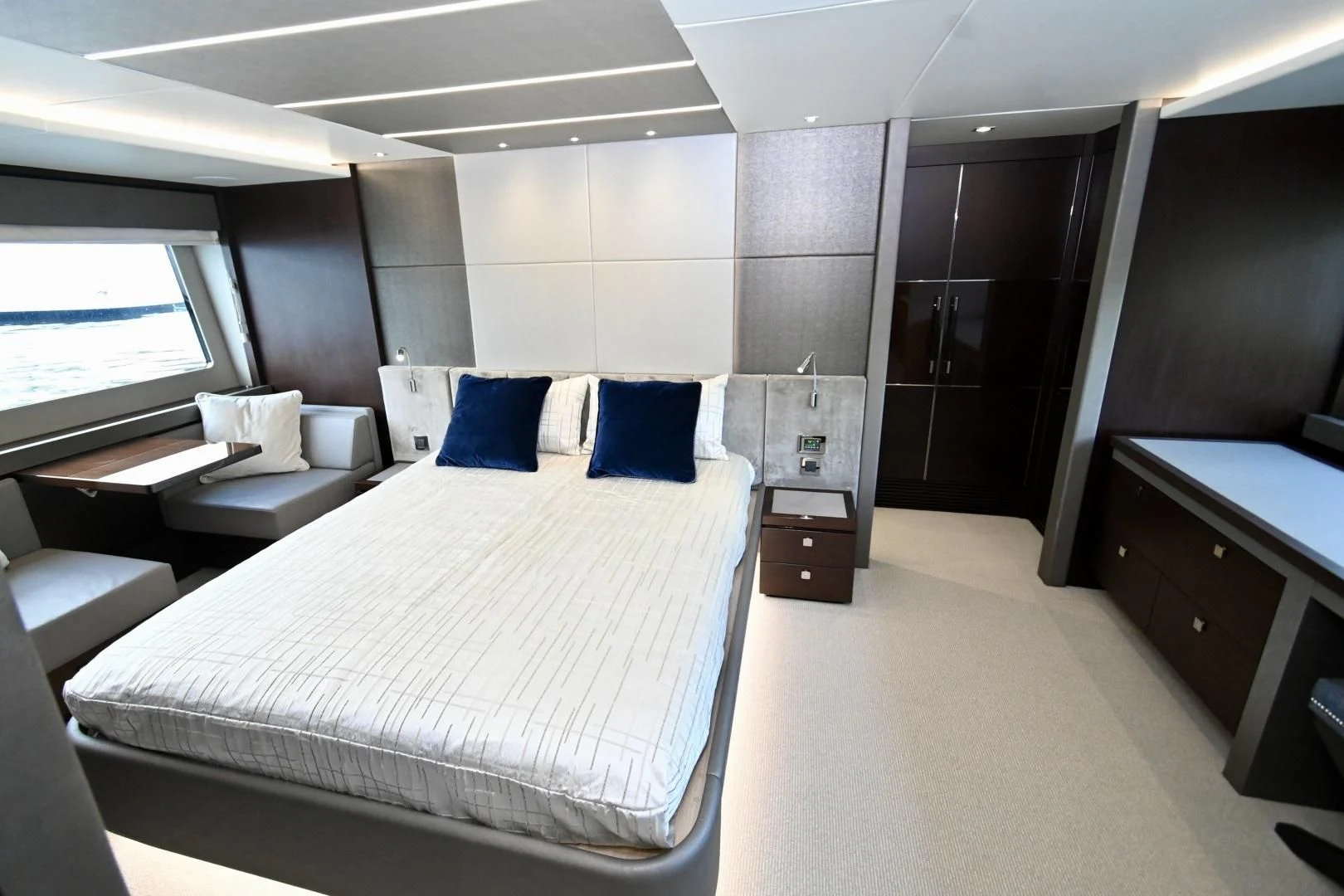 a room with a bed and desk aboard CAESURA Yacht for Sale