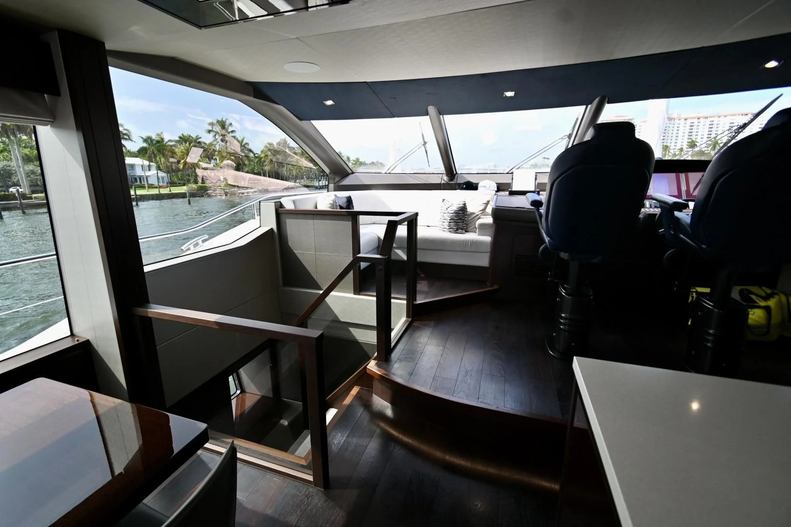 a deck with a view of the water and trees aboard CAESURA Yacht for Sale