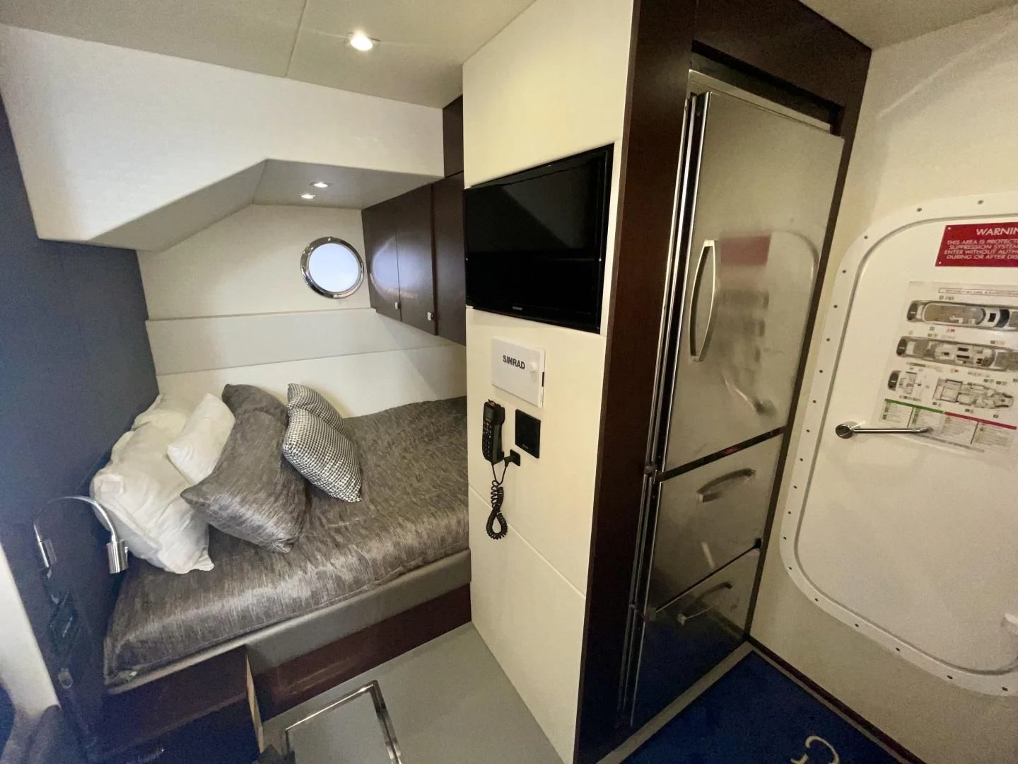 a room with a bed and a television aboard CAESURA Yacht for Sale