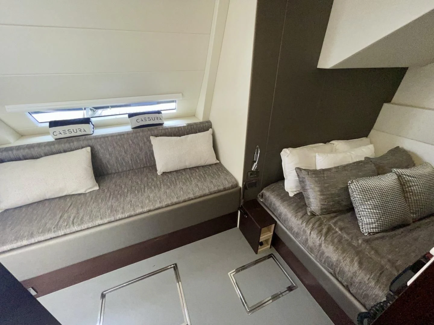 a living room with a couch and a coffee table aboard CAESURA Yacht for Sale