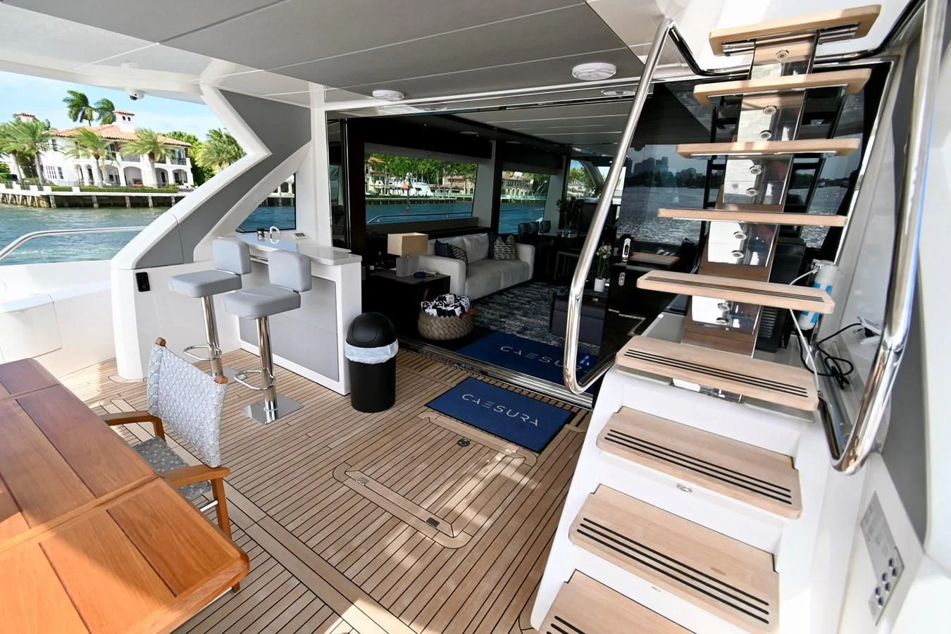 a room with a tv and a table and chairs aboard CAESURA Yacht for Sale