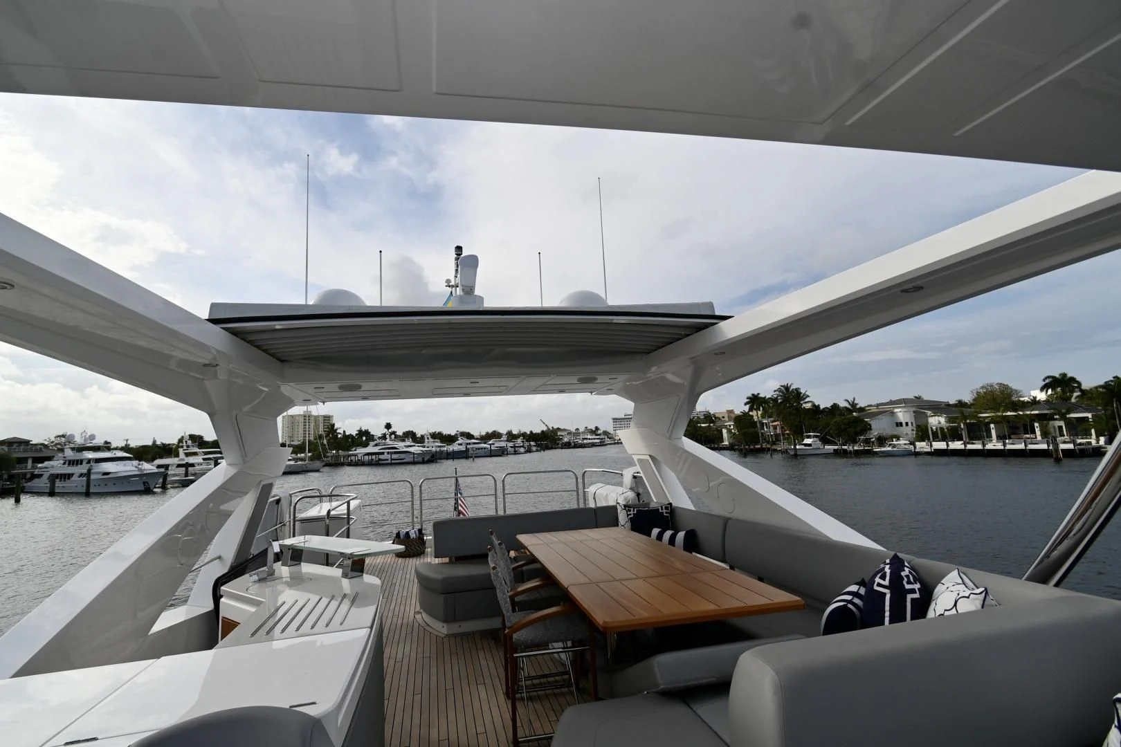 a boat deck with a large white building and a pool aboard CAESURA Yacht for Sale