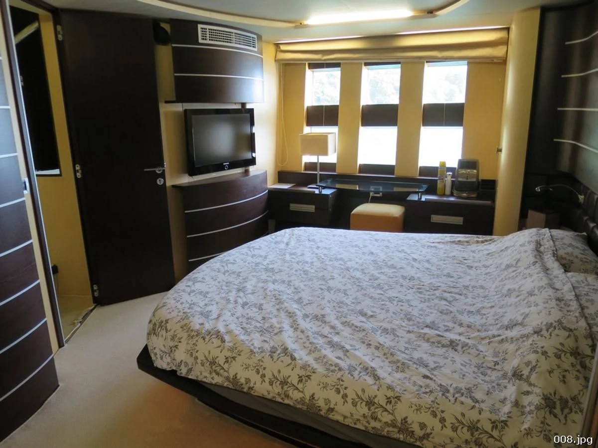 a bedroom with a bed and tv aboard AZIMUT 86S Yacht for Sale