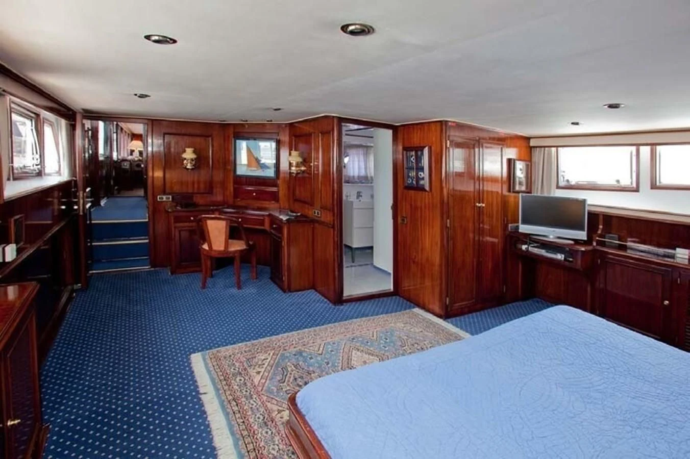 a bedroom with a bed and a desk aboard MISS EVA Yacht for Sale