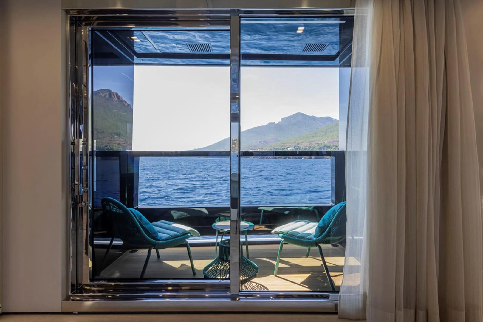 a room with a view of the ocean and mountains aboard 38M EXPLORER HULL 3 Yacht for Sale