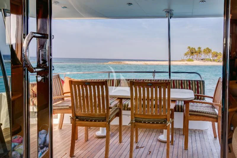 a deck with chairs and tables on it aboard EQUINOX X Yacht for Sale