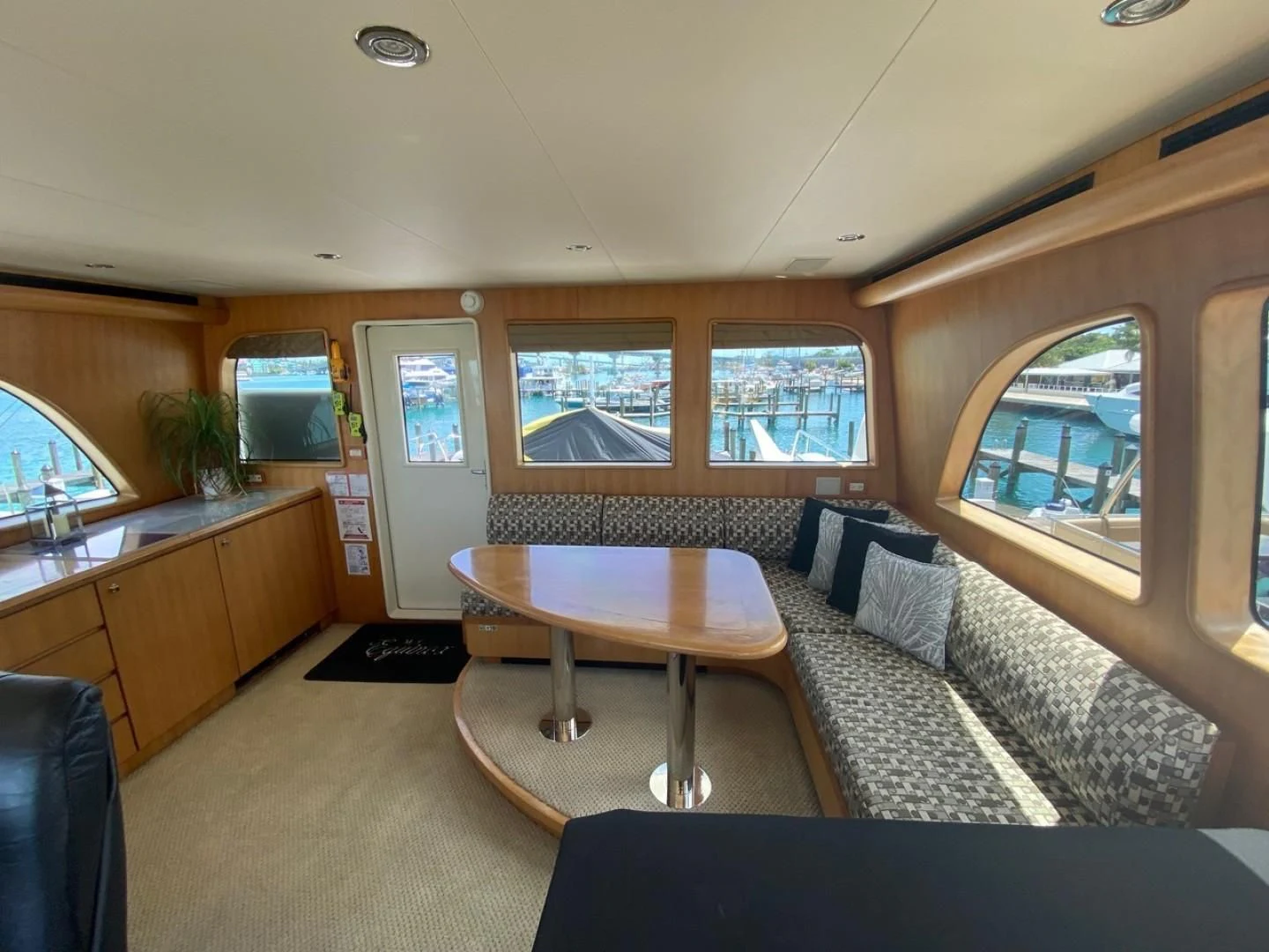a living room with a couch and a table aboard EQUINOX X Yacht for Sale