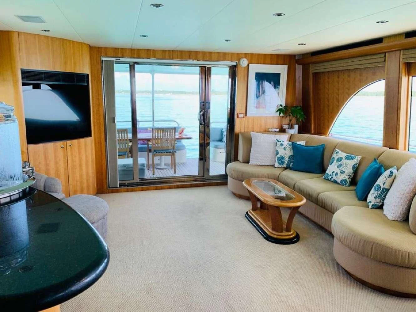 a living room with a couch and a tv aboard EQUINOX X Yacht for Sale