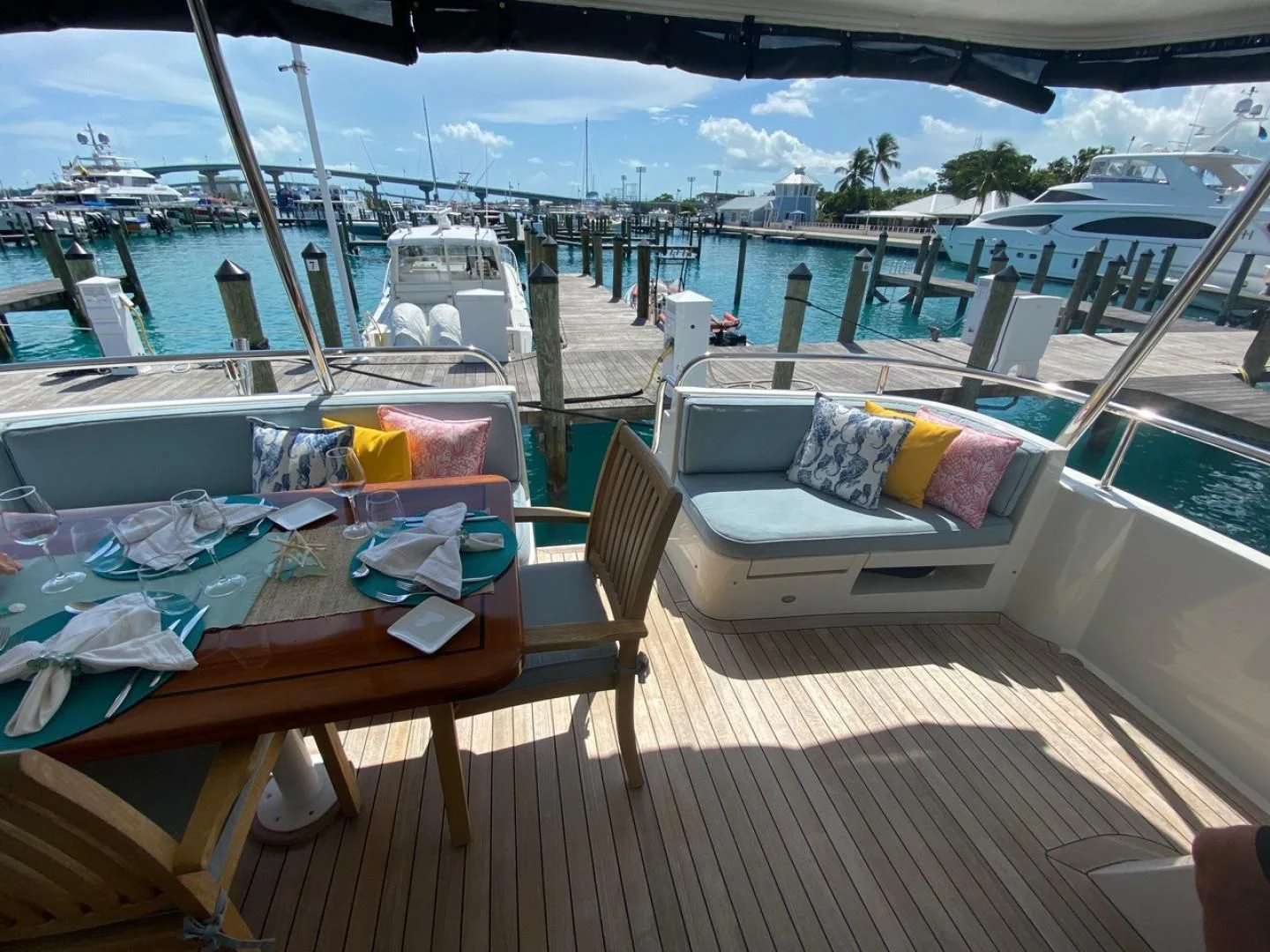 a deck with a view of the water and boats aboard EQUINOX X Yacht for Sale