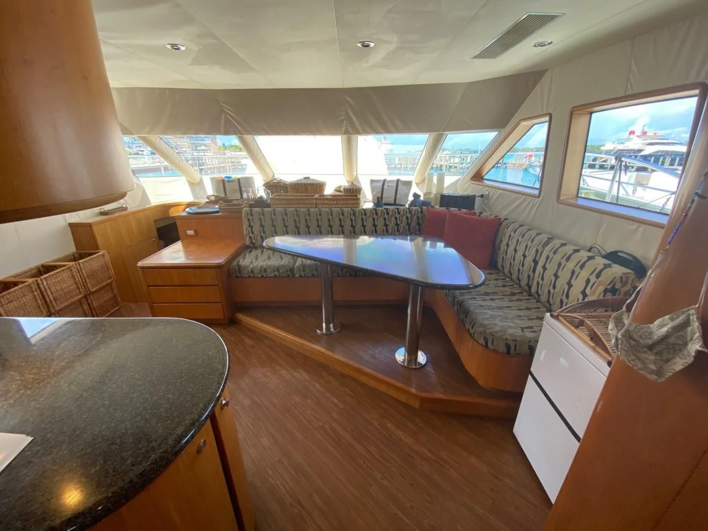 a room with a pool table and couches aboard EQUINOX X Yacht for Sale