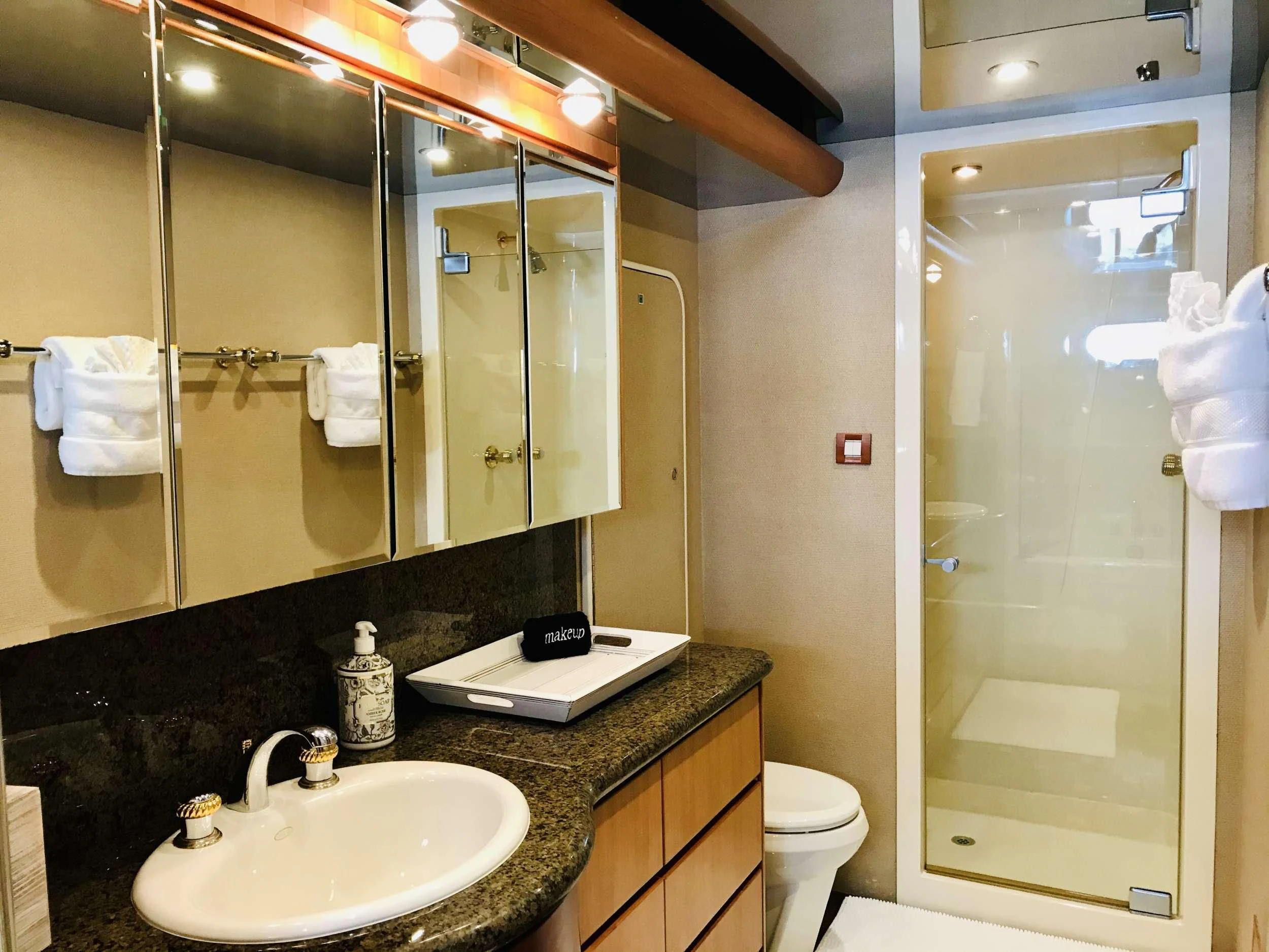 a bathroom with a large mirror aboard EQUINOX X Yacht for Sale