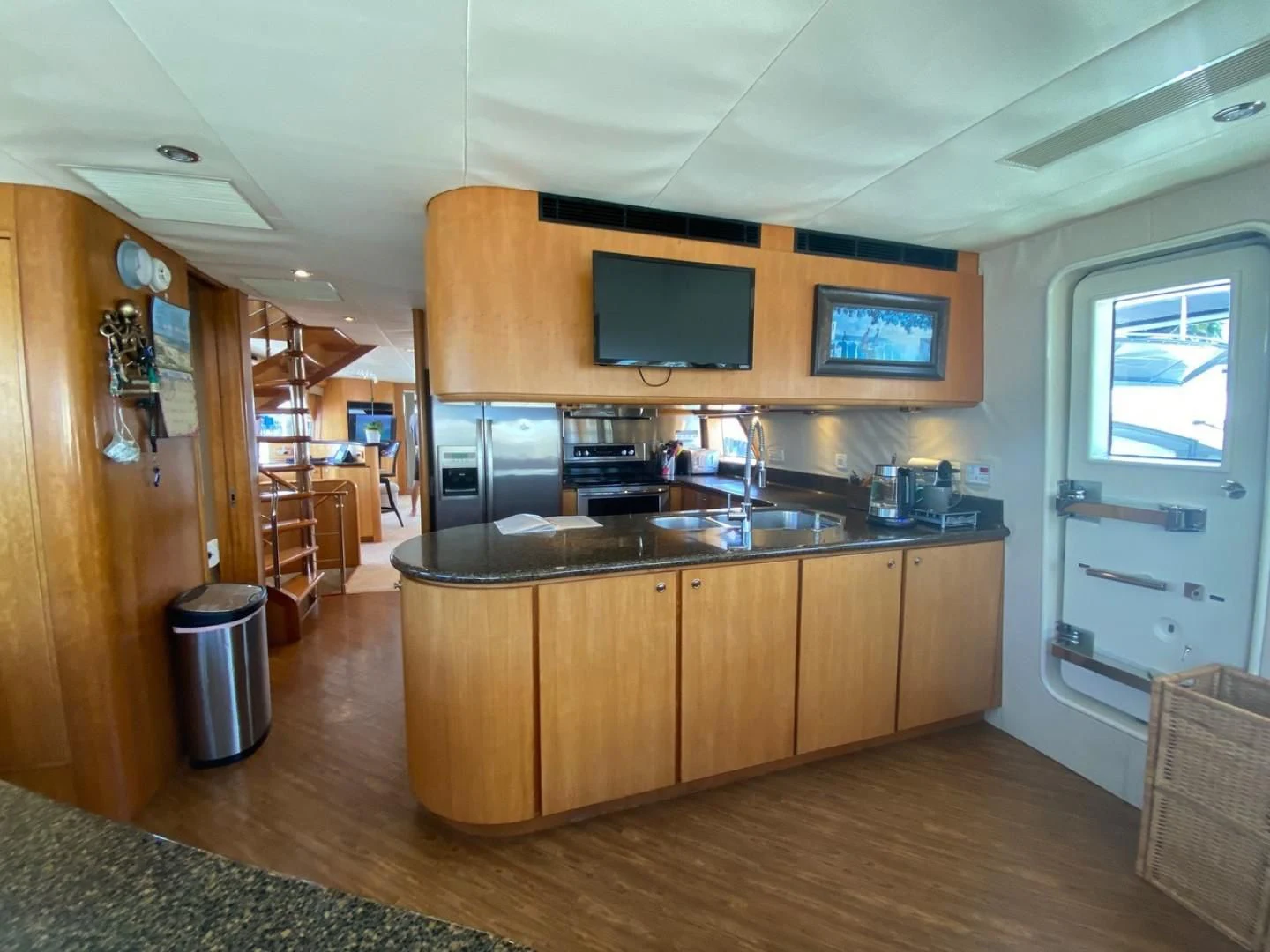 a kitchen with a large tv aboard EQUINOX X Yacht for Sale