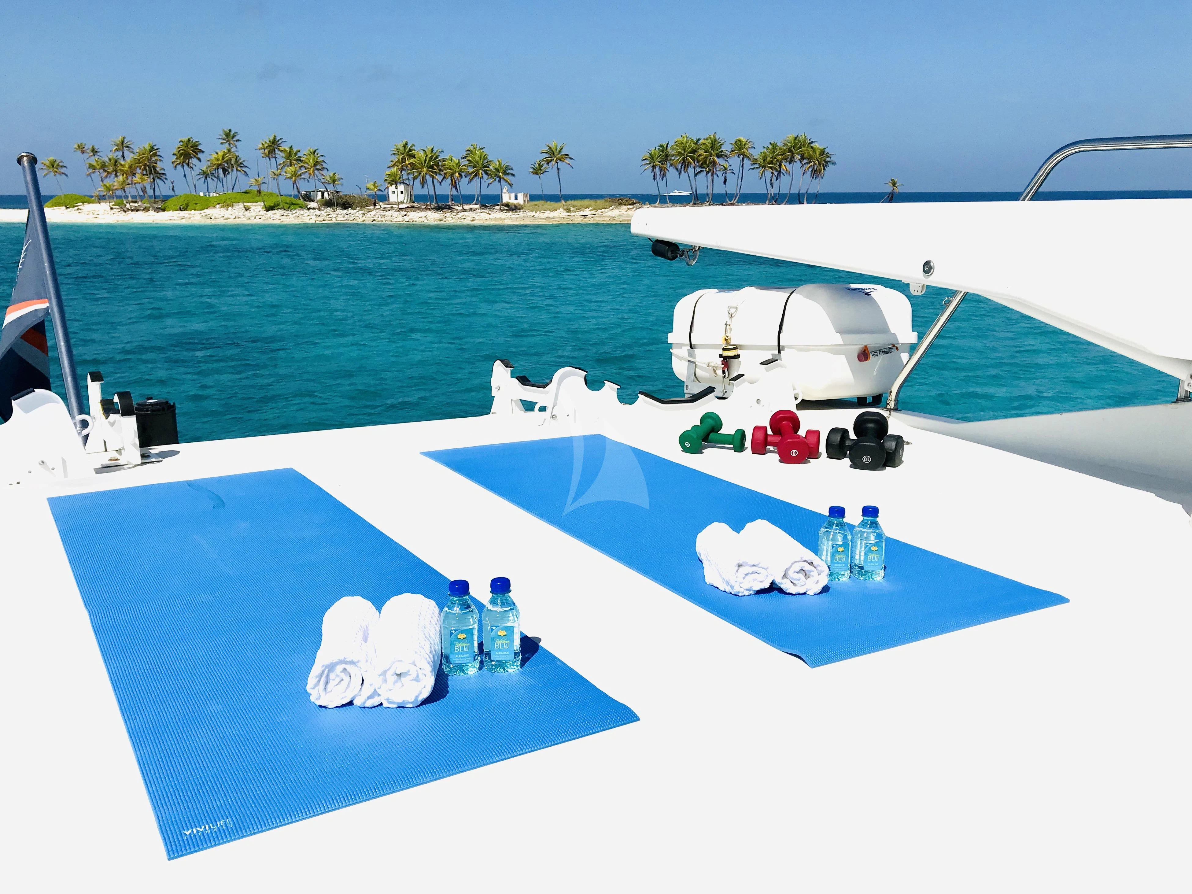 a pool with water and a boat in the background aboard EQUINOX X Yacht for Sale