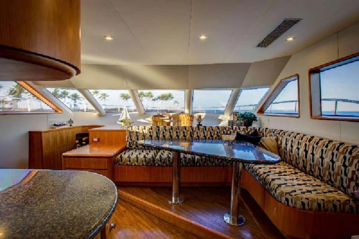 a room with a couch and a table aboard EQUINOX X Yacht for Sale
