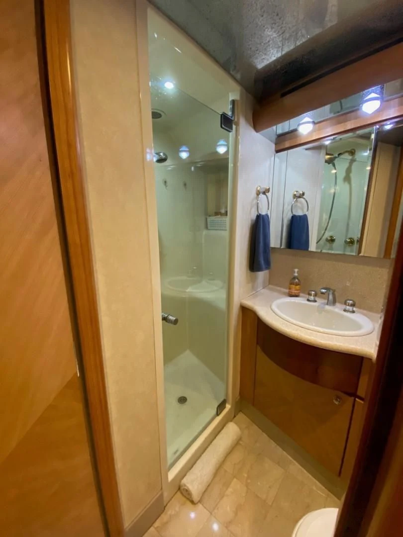 a bathroom with a glass shower door aboard EQUINOX X Yacht for Sale