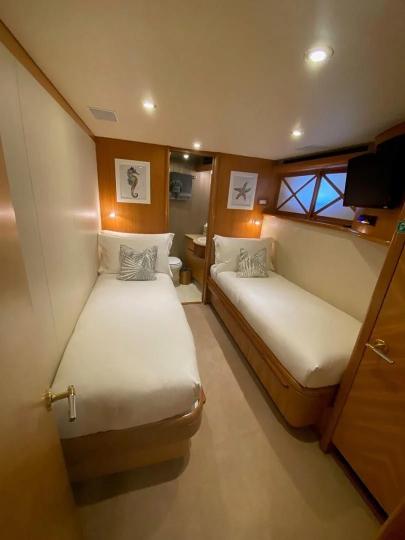 a room with a couple of beds aboard EQUINOX X Yacht for Sale