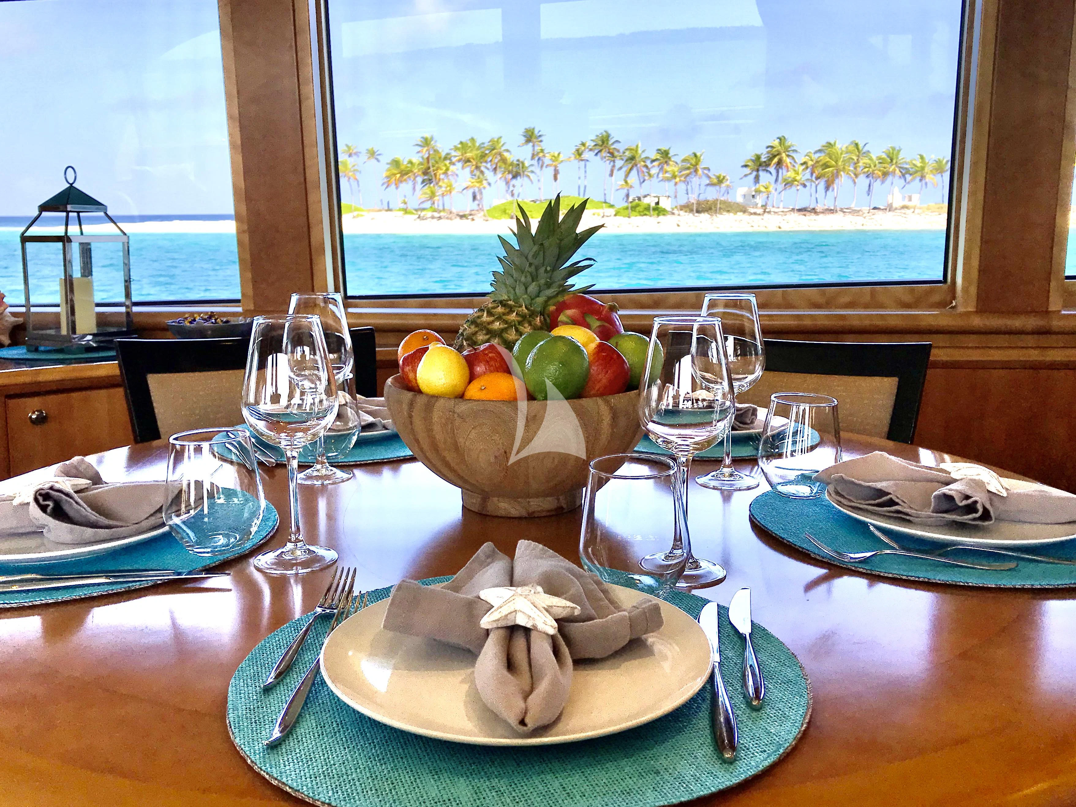a table with plates and glasses aboard EQUINOX X Yacht for Sale