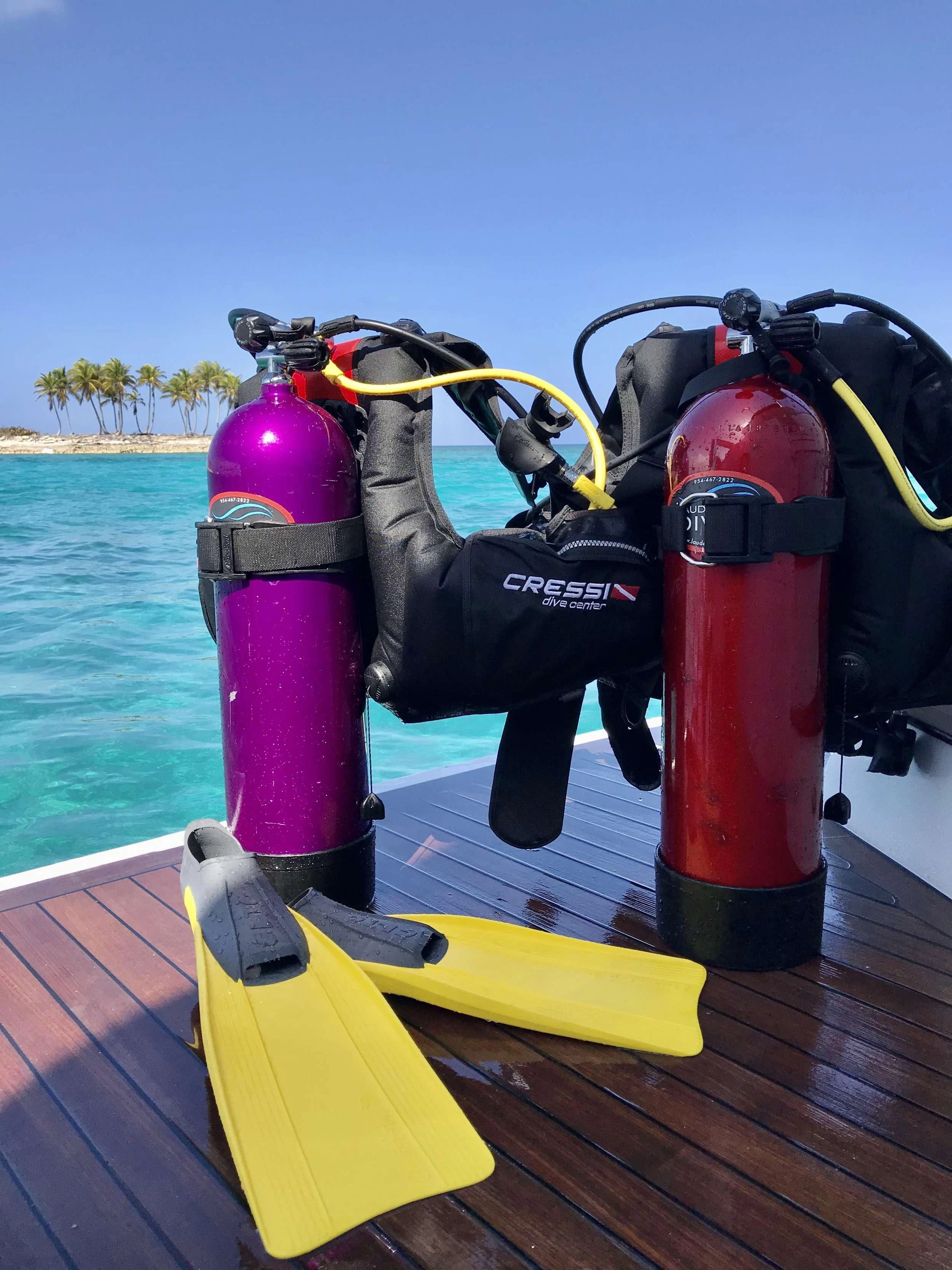 a person in a life jacket on a yellow and red boat aboard EQUINOX X Yacht for Sale
