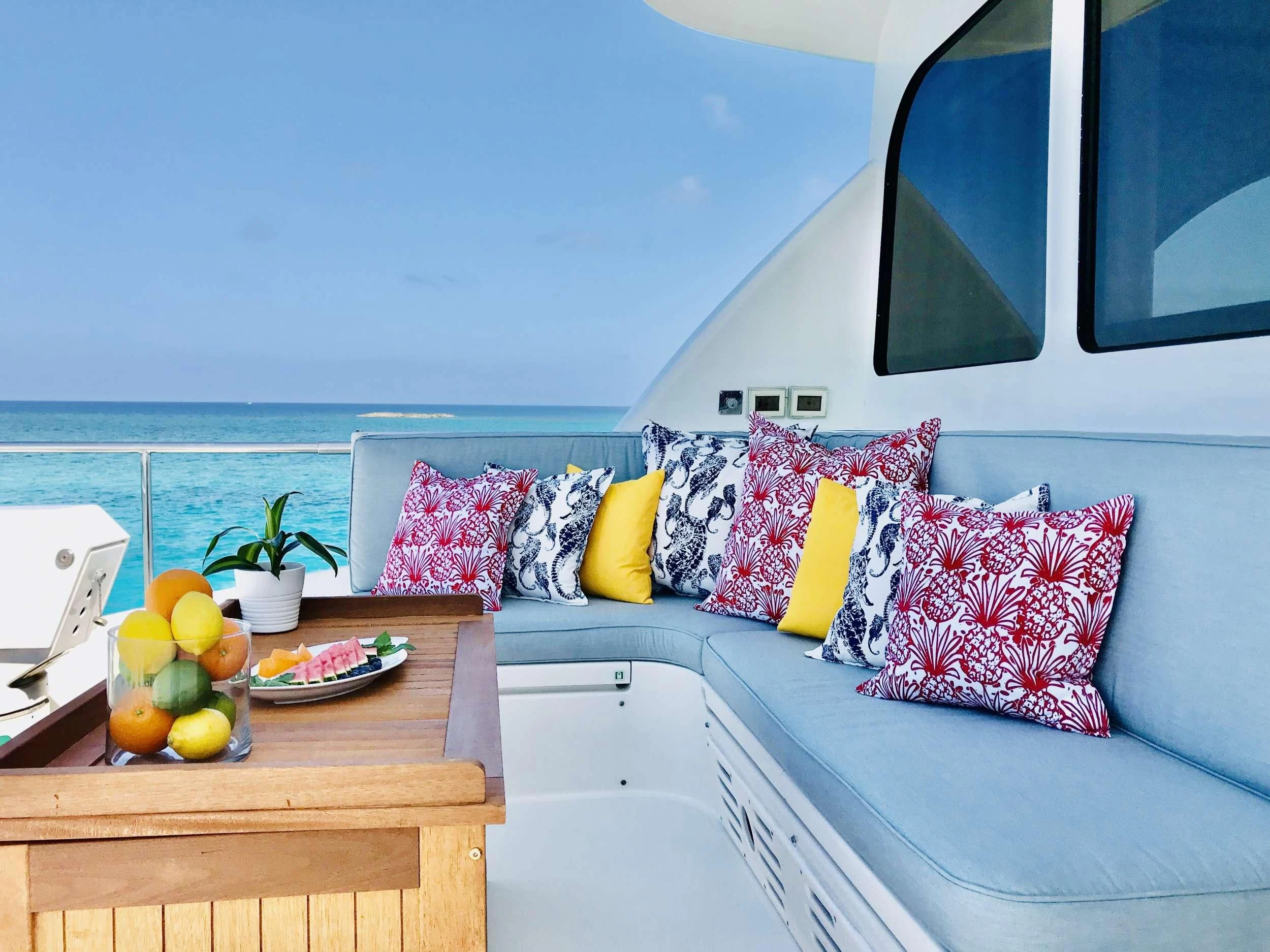 a room with a table and a bed aboard EQUINOX X Yacht for Sale