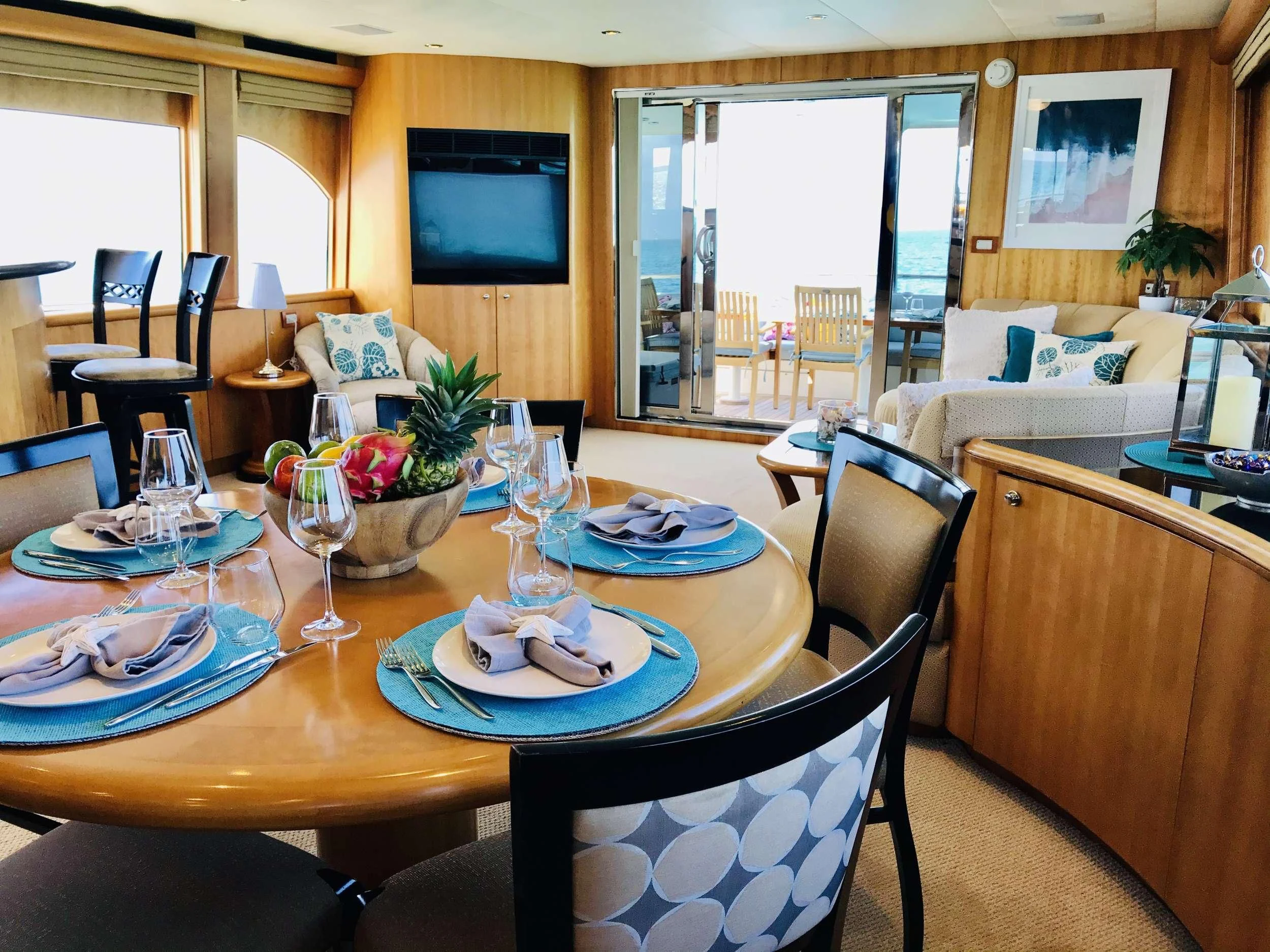a table with plates and glasses on it aboard EQUINOX X Yacht for Sale