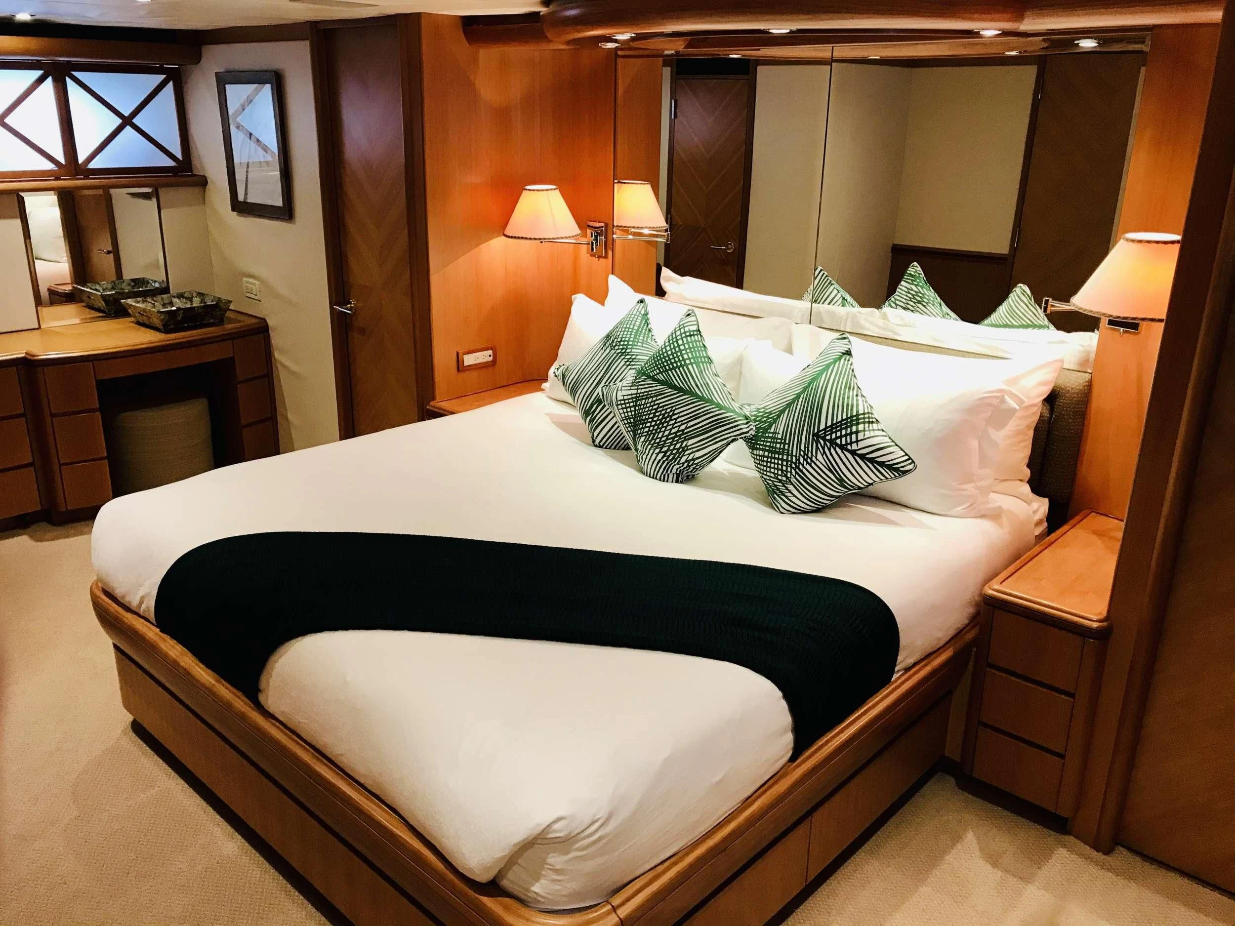 a bed with white sheets aboard EQUINOX X Yacht for Sale