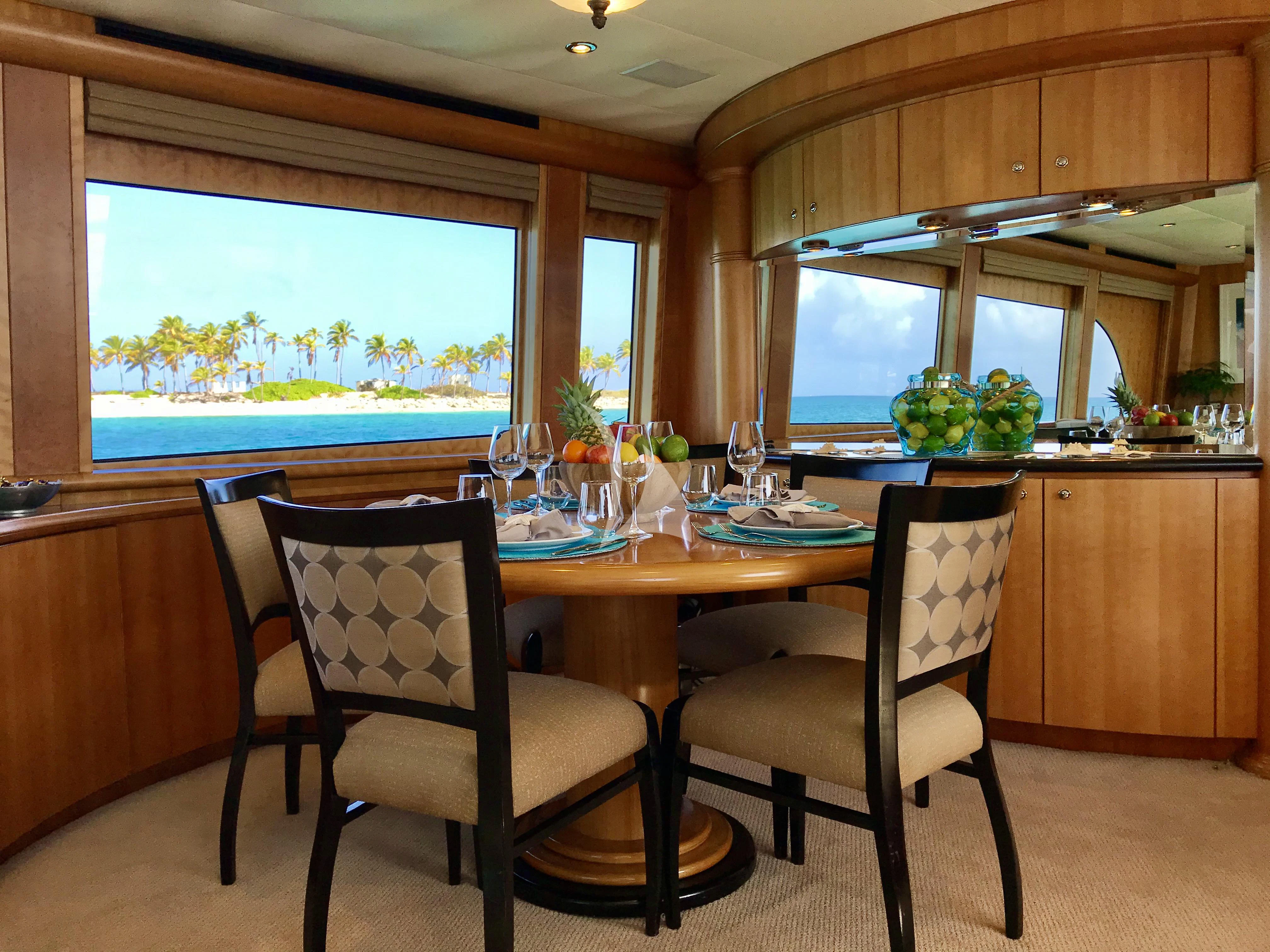 a kitchen with a table and chairs aboard EQUINOX X Yacht for Sale