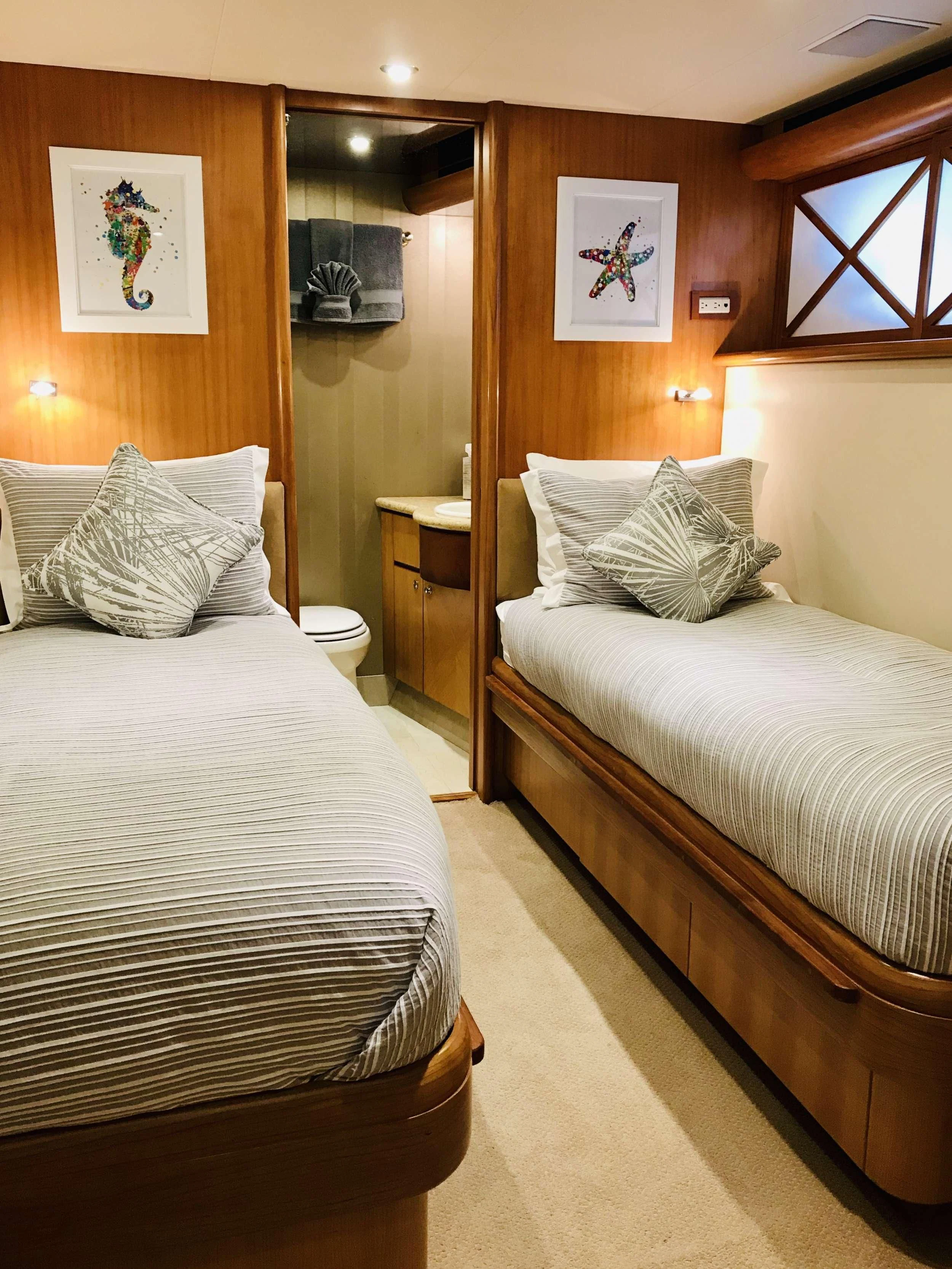 a room with two beds aboard EQUINOX X Yacht for Sale