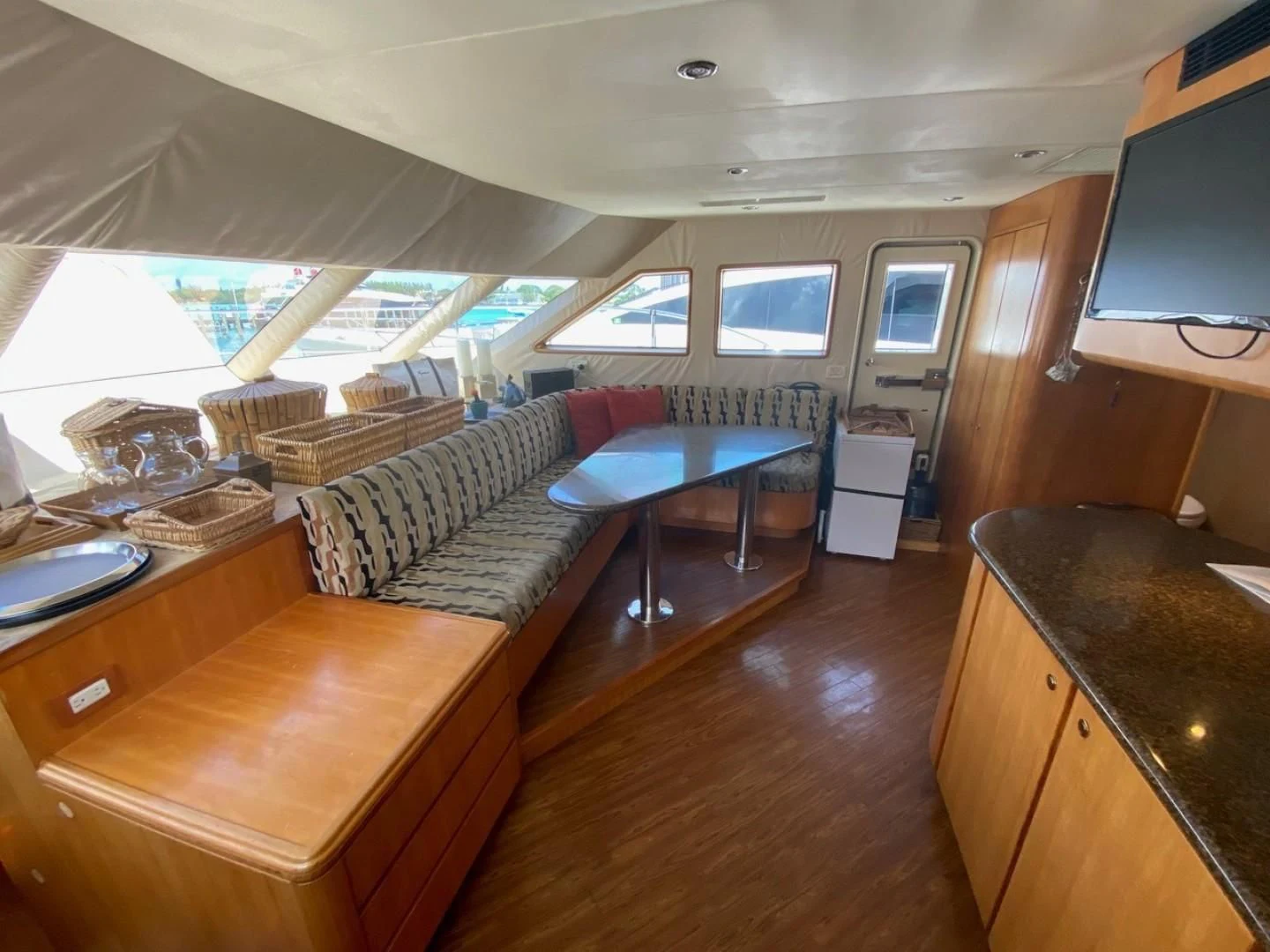 a living room with a couch and a tv aboard EQUINOX X Yacht for Sale
