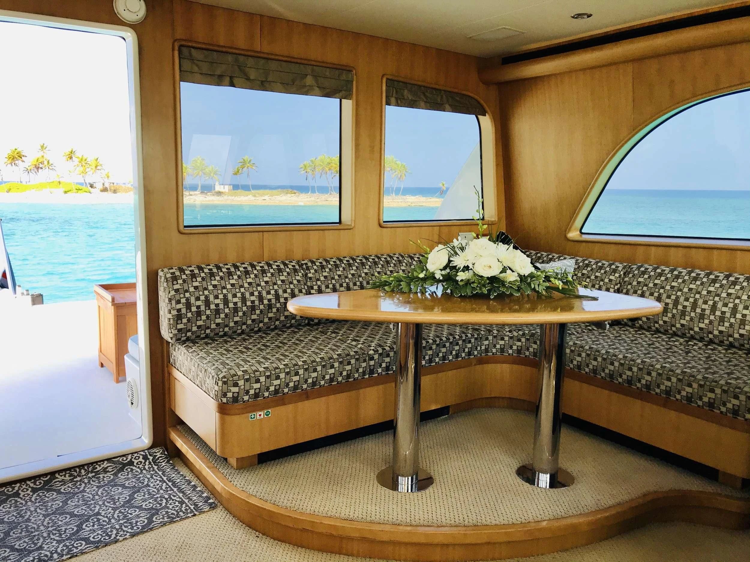 a coffee table in a living room aboard EQUINOX X Yacht for Sale