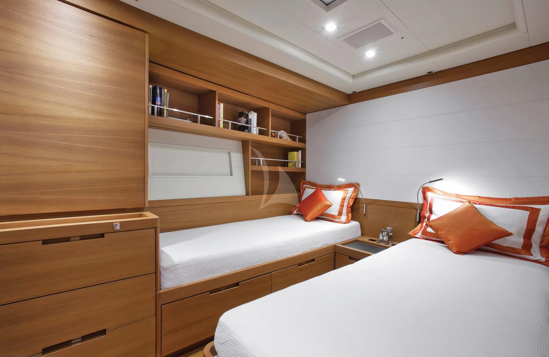 a room with a bed and a shelf with books on it aboard ARAGON Yacht for Sale