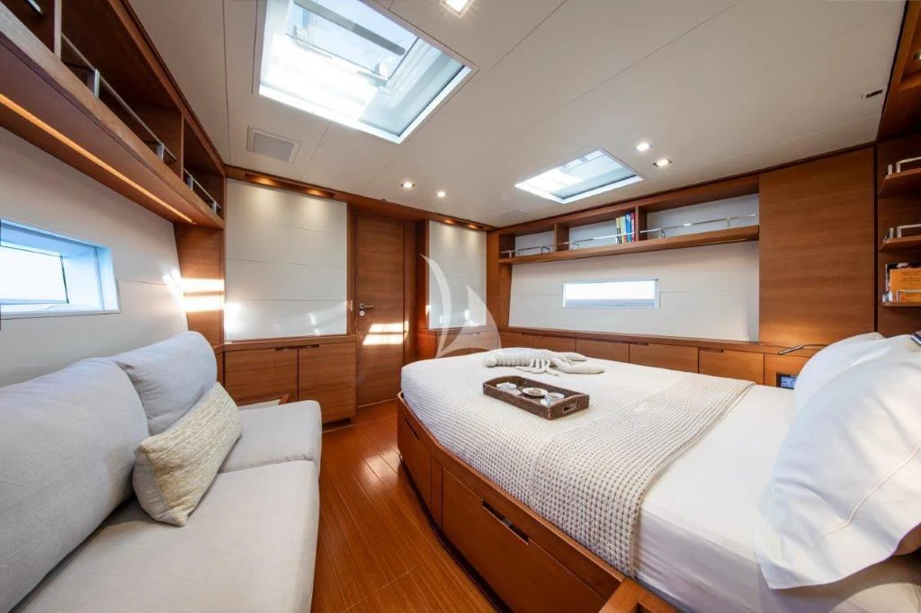a bedroom with a bed and a couch aboard ARAGON Yacht for Sale