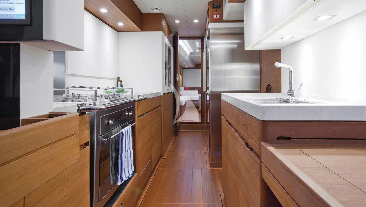 a kitchen with wooden cabinets aboard ARAGON Yacht for Sale