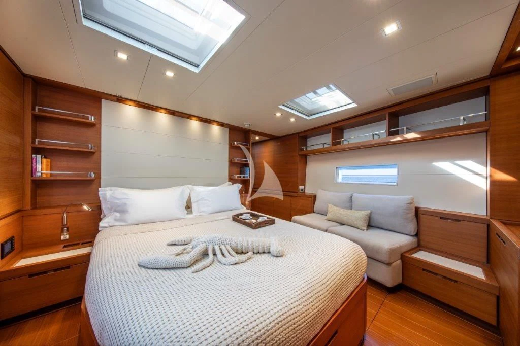 a bedroom with a bed and a desk aboard ARAGON Yacht for Sale