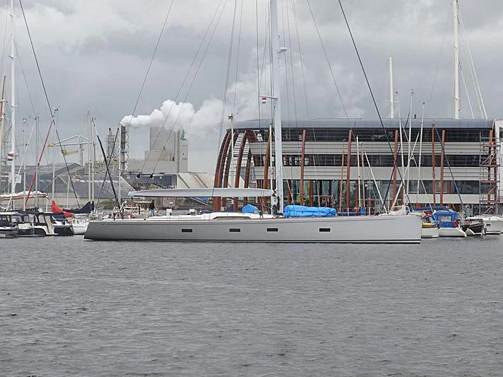 a large white boat in a harbor aboard ARAGON Yacht for Sale