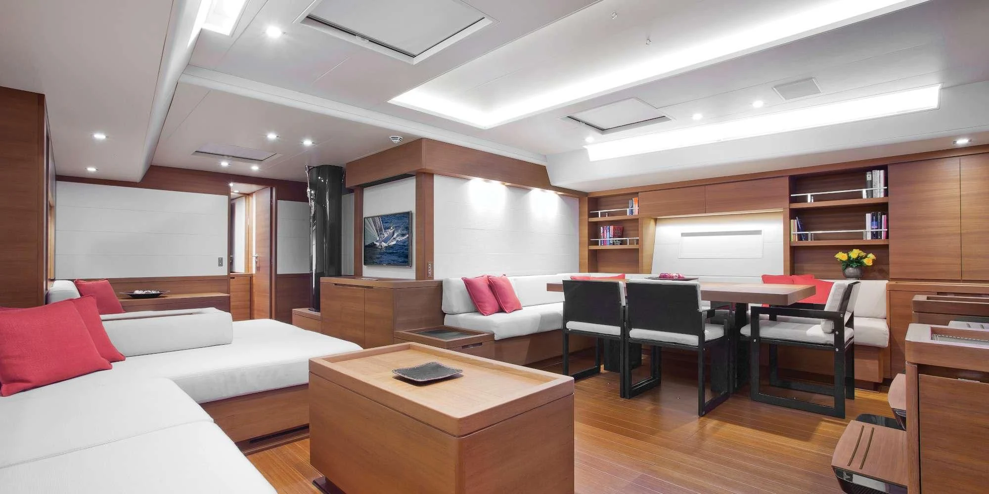 a living room with a table and couches aboard ARAGON Yacht for Sale