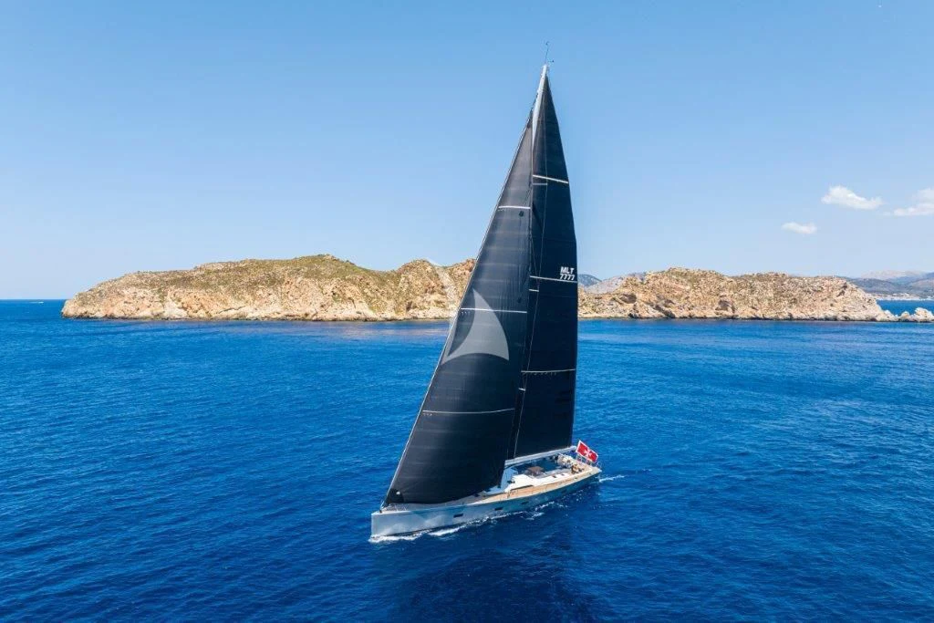 a black and white sailboat on the water aboard ARAGON Yacht for Sale