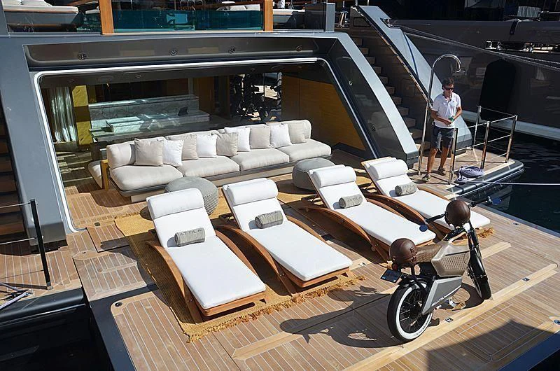a person standing next to a motorcycle aboard ATTILA Yacht for Sale